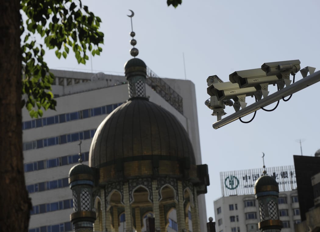 Security cameras are seen (right) on a street in Urumqi, capital of China's Xinjiang region on July 2, 2010.