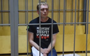 Russian investigative journalist Ivan Golunov, charged with attempted drug-dealing, sits inside a defendants' cage during a hearing at a court in Moscow on 8 June 2019.