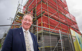 Nick Smith outside one of the Special Housing Areas in Auckland