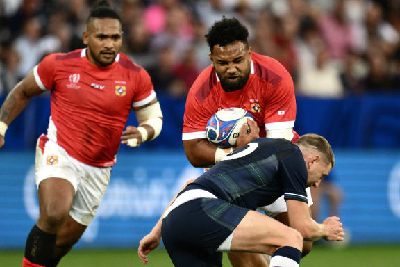 Tonga's back row Sione Vailanu (up) is tackled by Scotland's fly-half Finn Russell   during the France 2023 Rugby World Cup Pool B match between Scotland and Tonga at Stade de Nice in Nice, southern France on September 24, 2023. (Photo by CHRISTOPHE SIMON / AFP)