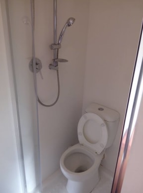 The shower fitted over a toilet in the West Auckland unit.