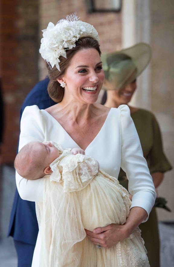 Britain's Catherine, Duchess of Cambridge holds Britain's Prince Louis of Cambridge on their arrival for his christening service.