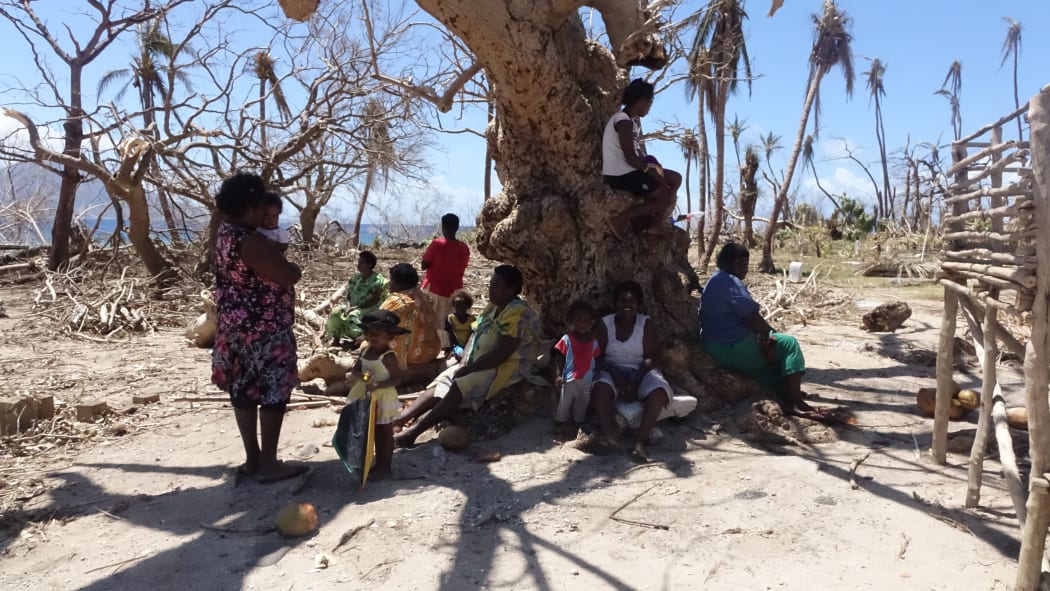 Women seek refuge from the scorching sun. With no leaves on the trees and no roofs on their houses, exposure to the elements was a major concern.