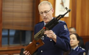 Acting Superintendant Michael McIlraith demonstrates how semi-automatic weapons can be illegally modified