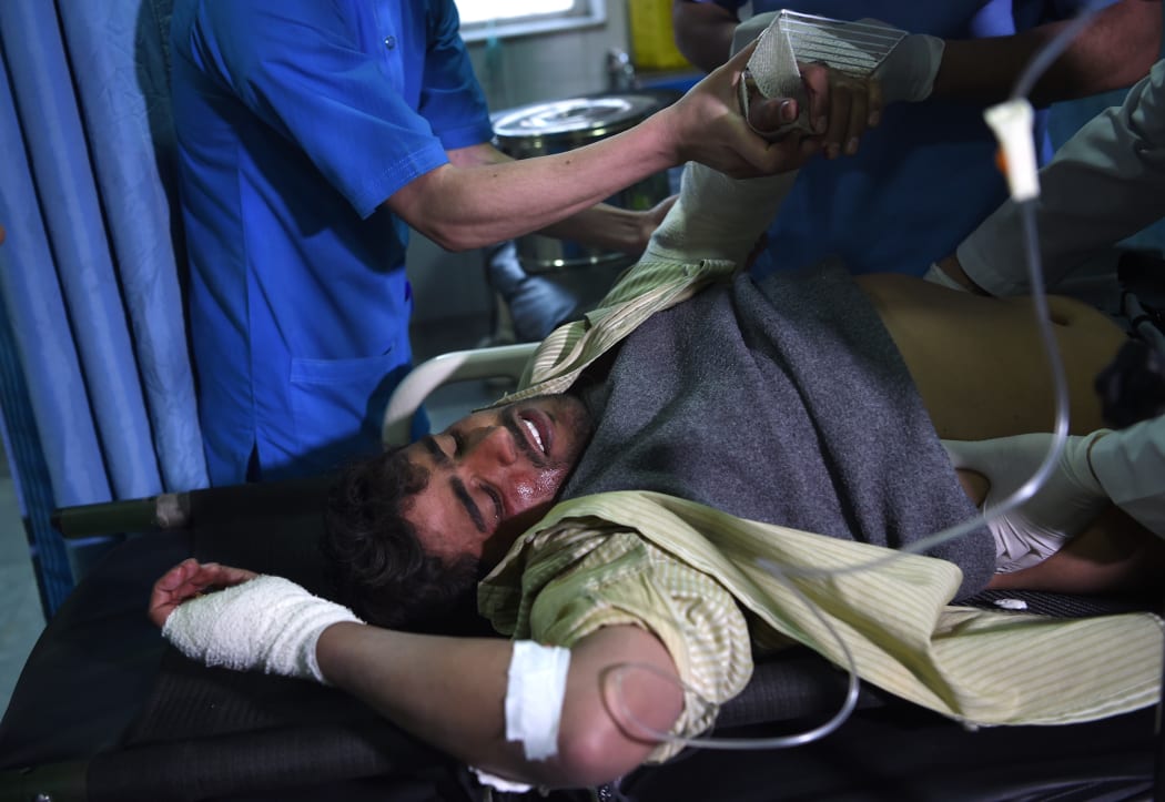 A wounded Afghan man receives treatments at a hospital after a car bomb attack in Kabul.