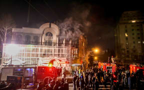 Iranian protesters set fire to the Saudi Embassy in Tehran.