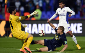 Cruz Azul's forward Joao Rojas (R) is pressured by Auckland City's defender John Irving (C) and goalkeeper Jacob Spoonley during their FIFA Club World Cup third place play-off in Marrakesh.