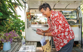Opotiki’s mayor Lyn Riesterer scans in at Kafe Friends coffee cart in the Opotiki CBD and would like the rest of the community to do the same.