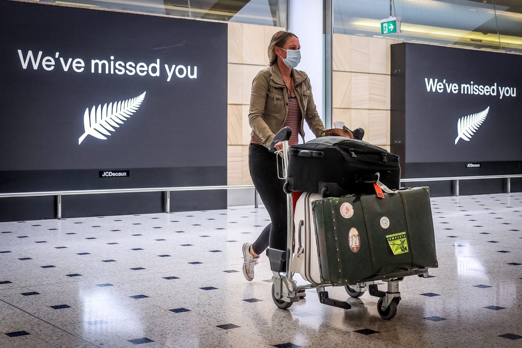 A passenger wearing a face mask arrives from New Zealand at Sydney International Airport on October 16, 2020, after Australias border rules were relaxed under a new one-way trans-Tasman travel agreement.