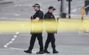 Armed police patrol outside the scene of the Manchester explosion.