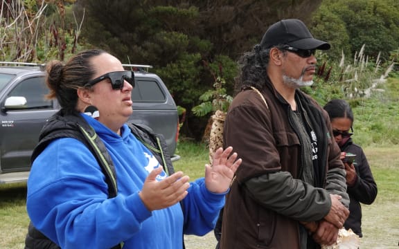 Keringawai Evans, occupation coordinator and vice-chairperson of Haititaimarangai Marae, addresses the crowd flanked by Reuben Taipari, leader of a long-running occupation at Ahipara.