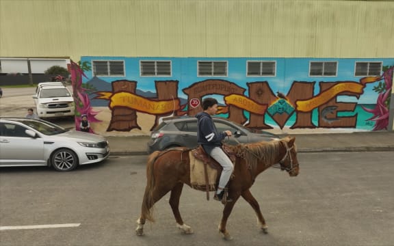 Boy rides horse in Ikaroa-Rāwhiti