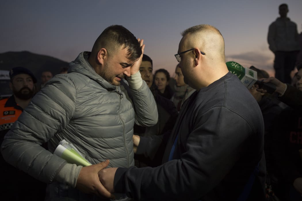 Jose Rosello (L), father of Julen who fell down a well, cries as rescue efforts continue to find the boy in Totalan in southern Spain.
