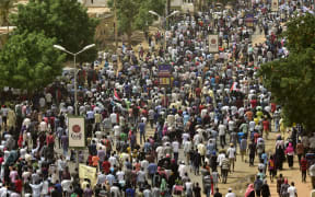 Sudanese protesters march in a mass demonstration against the country's ruling generals in the capital Khartoum's twin city of Omdurman.