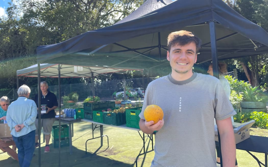 Finn holds an orange from his mystery box.