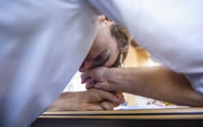 Office worker head down exhausted on table (file photo)