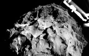 The comet shown from a camera on Philae about 3km from the surface. A segment of the probe's landing gear is visible in the upper right hand corner.