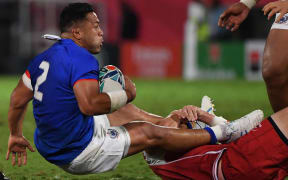 Samoa's hooker Motu Matu'u (L) is tackled by Russia's number 8 Nikita Vavilin during the Japan 2019 Rugby World Cup Pool A match between Russia and Samoa at the Kumagaya Rugby Stadium in Kumagaya on September 24, 2019. (Photo by William WEST / AFP)