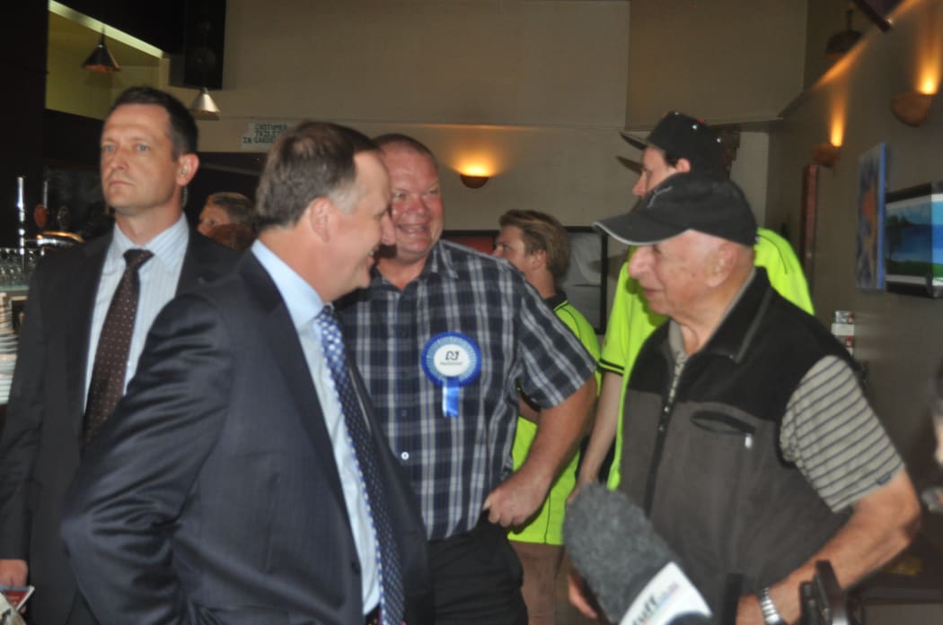 Prime Minister John Key, second left, and National candidate Mark Osborne in Northland on 26 March 2015.