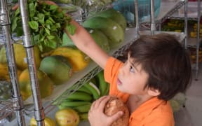 Photo taken by Annabel Lyman of Palau, showing her grandson choosing healthy food