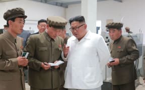 This undated picture released by North Korea's official Korean Central News Agency on July 17, 2018 via KNS shows North Korean leader Kim Jong Un (2nd R) inspecting the September 1 Machine Factory under the Ranam Coal-mining Machine Complex in North Hamgyong Province.