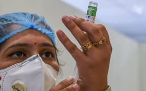 A medical worker prepares to inoculate a colleague with a Covid-19 coronavirus vaccine at a hospital in New Delhi.