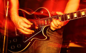 14291219 - closeup of an guitarist at a rock concert, motioneffect!