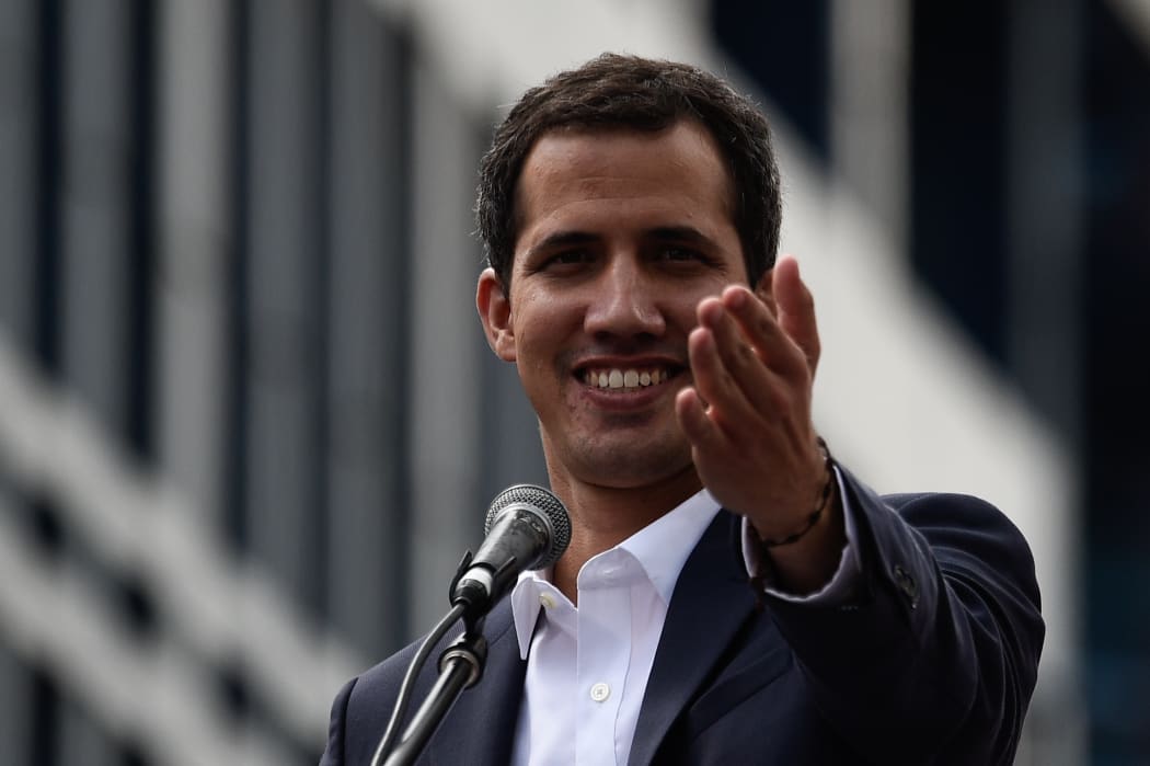 Venezuela's National Assembly head Juan Guaido speaks to the crowd during a mass opposition rally against leader Nicolas Maduro in which he declared himself the country's "acting president", on the anniversary of a 1958 uprising that overthrew a military dictatorship, in Caracas on January 23, 2019.