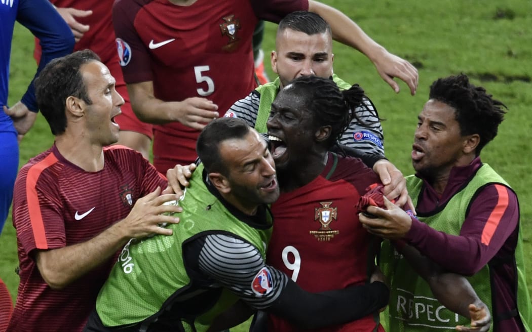 Portugal's forward Eder (C) celebrates after scoring a goal with team mates during the Euro 2016 final football match between Portugal and France at the Stade de France in Saint-Denis, north of Paris, on July 10, 2016.