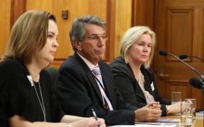 Chief Ombudsman Judge Peter Boshier (center), Deputy Ombudsman Compliance  and Practice Emma Leach (left) and Chief Inspector OPCAT Jacki Jones, (right) speak to the Law and Order Committee about the illegal restraint of at risk prisoners.