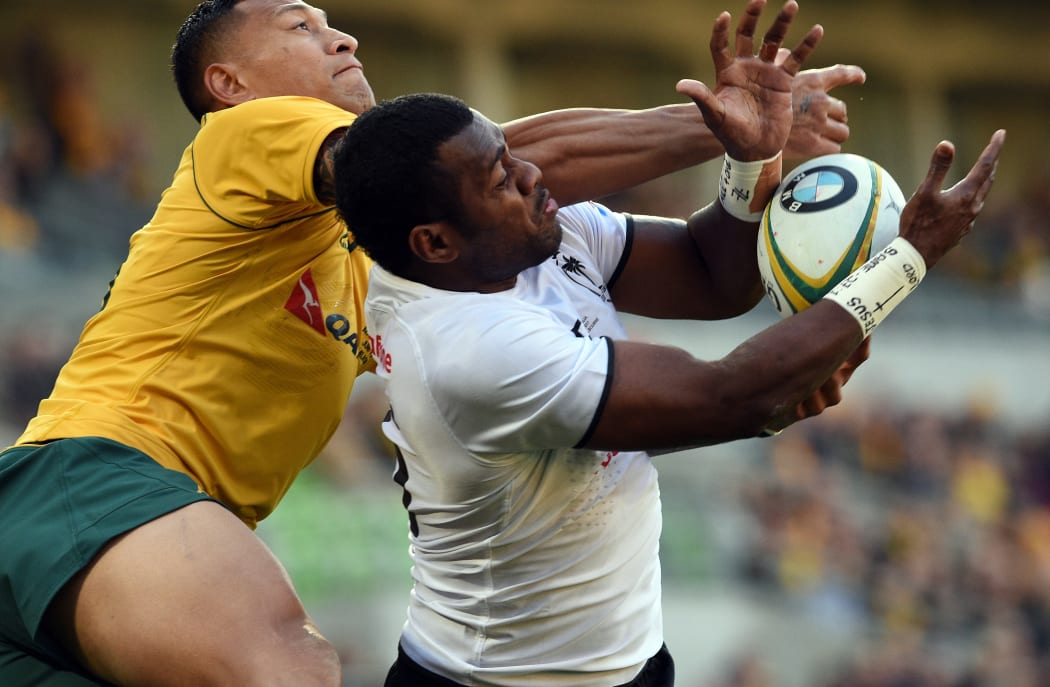 Fiji's Kini Murimurivalu tries to tackle Australia's Israel Folau.