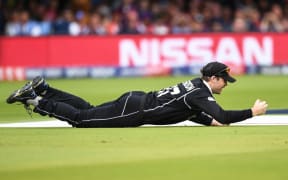 Lockie Ferguson takes a catch to take the wicket of Morgan at the Cricket World Cup final.