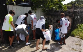 Red Cross volunteers cleaning up mosquito breeding sites in Majuro