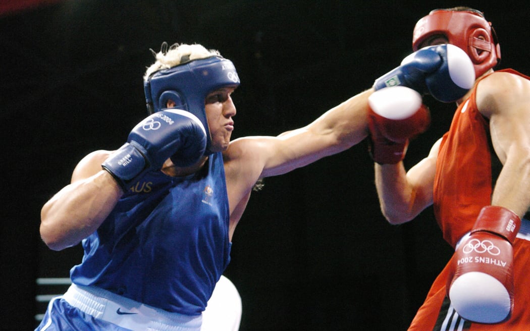 Athens, GREECE:  Adam Forsyth (L) of Australia (L) extends a left against Vedran Djipalo (R) of Croatia during their Olympic Games preliminary Heavyweight (91 kg) match at the Peristeri Boxing Hall 18 August 2004 in Athens. Djipalo, who was penalized 2 points for a low blow in the fourth round, lost to Forsyth on a 32-22 points decision. AFP PHOTO / JOE KLAMAR  (Photo credit should read JOE KLAMAR/AFP via Getty Images)