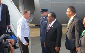 John Key is met by the PNG Foreign Minister Rimbink Pato, in Port Moresby.