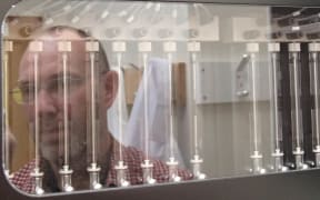 Aaron Jeffs and a genome sequencing machine