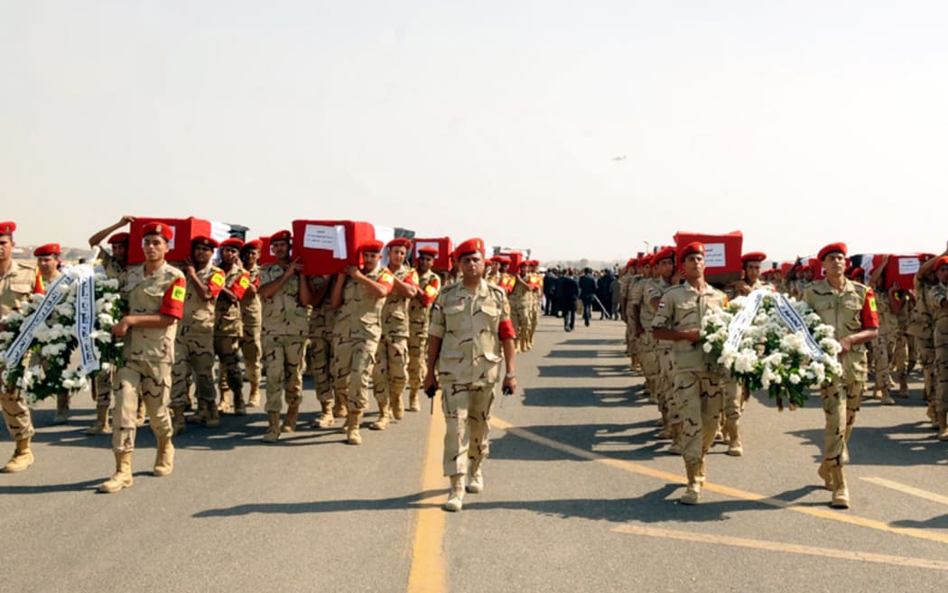 Coffins are carried in the funeral for 30 solders killed in the latest outbreak of violence in the Sinai Peninsula.