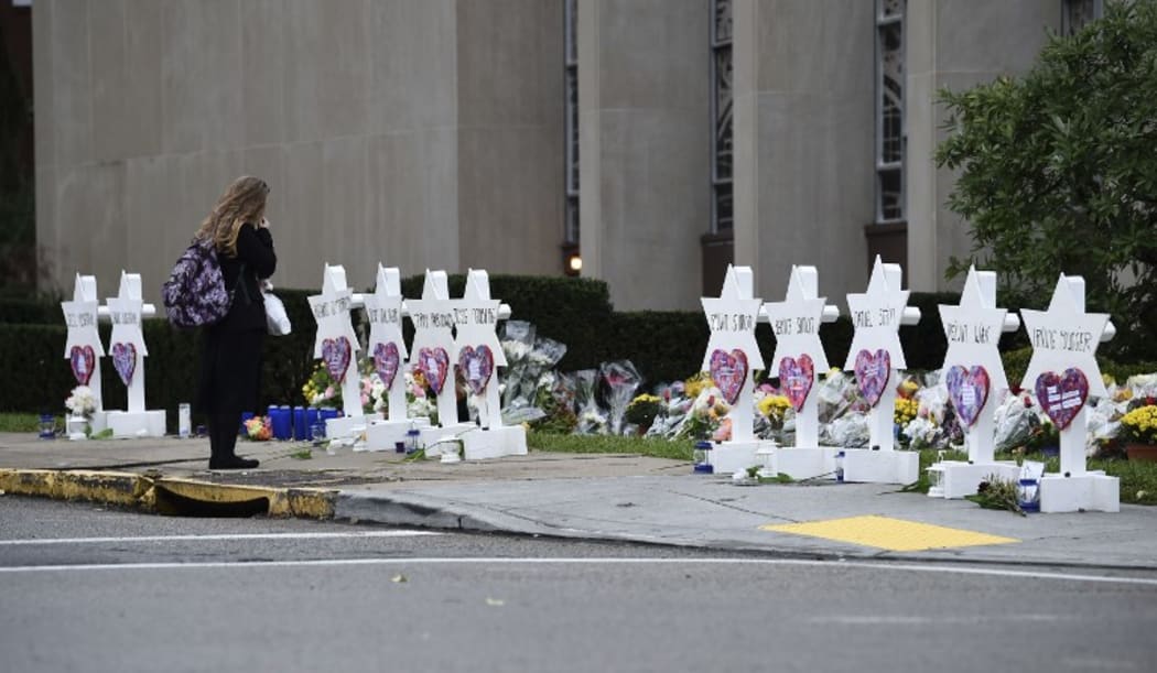 A woman stands at a memorial outside the Tree of Life synagogue in Pittsburgh after a shooting there left 11 people dead.