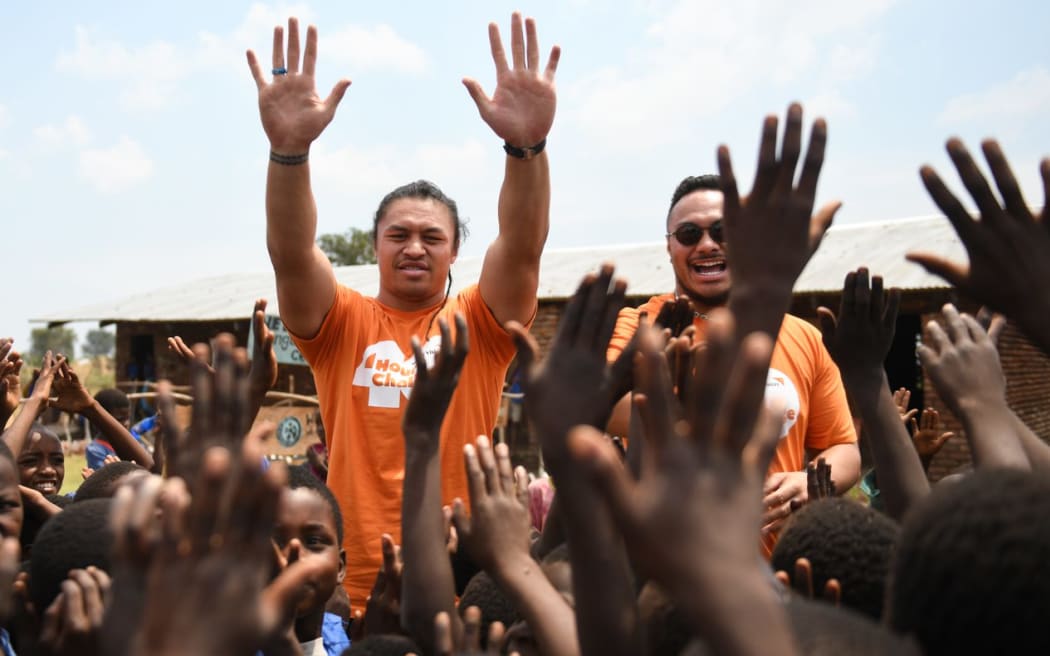 Caleb Clarke's waves to the crowds in Malawi.