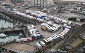 Freight lorries are seen parked at Dover Marina in Kent, south east England on December 22, 2020, adjacent to the Port of Dover as queuing trucks wait to continue their journeys after France closed its borders to accompanied freight arriving from the UK