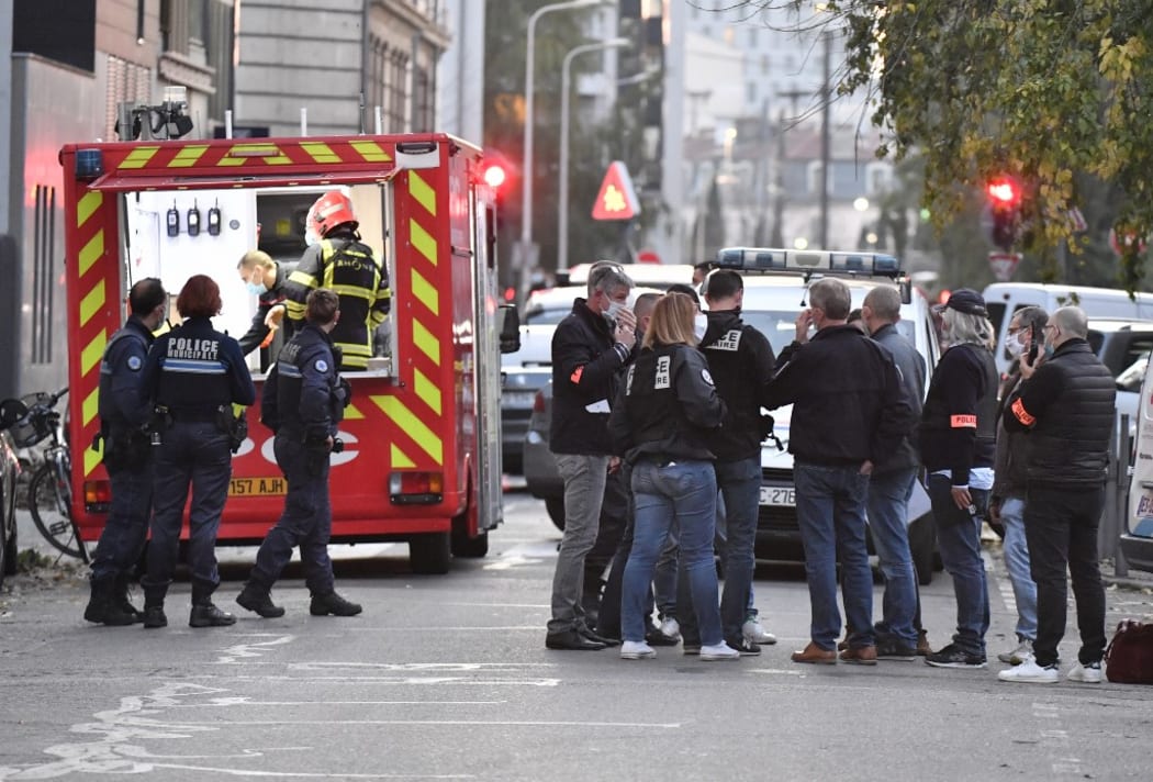 Security and emergency personnel are on October 31, 2020 in Lyon at the scene where an attacker armed with a sawn-off shotgun wounded an Orthodox priest in a shooting before fleeing, said a police source.