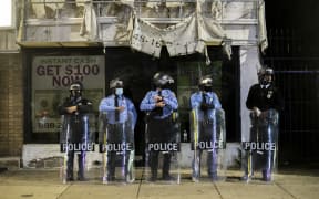 Police officers congregate an hour before a citywide curfew in Philadelphia on 28 October 2020, The mayor introduced the 9pm curfew for after two consecutive nights of unrest in response to the fatal shooting of Walter Wallace Jr by police.