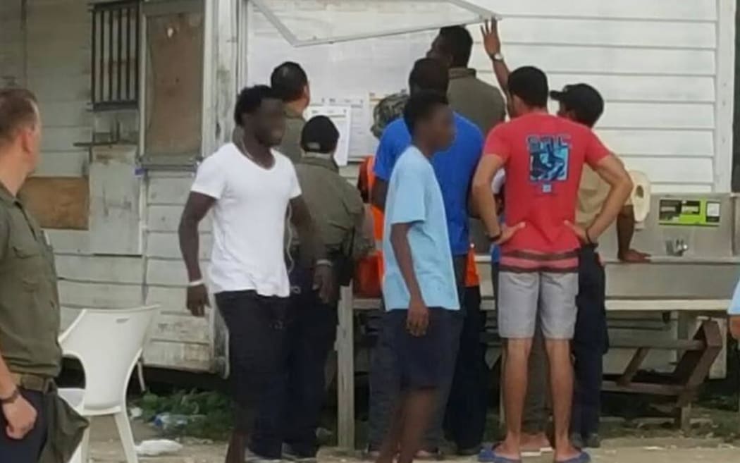Manus refugees checking the detention noticeboard