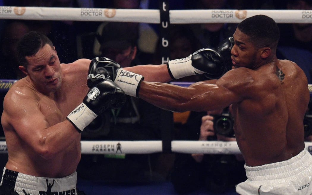 Anthony Joshua (R) of Great Britain exchanges blows with Joseph Parker (L) of New Zealand during their heavyweight unification bout at Principality Stadium in Cardiff, March 31, 2018.