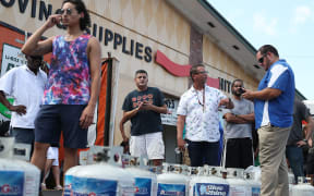 BOYNTON BEACH, FLORIDA - AUGUST 30: People wait in line at a U-Haul store to fill their propane tanks before the possible arrival of Hurricane Dorian on August 30, 2019 in Boynton Beach, Florida.