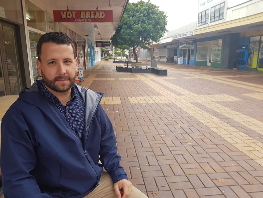 Hutt City Councillor Campbell Barry with an empty shopping centre in the background.