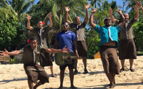 Tourism staff in Fiji greet visitors to their resort in the Yasawa Islands