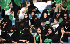 Saudi women sit in a stadium for the first time to attend an event in the capital Riyadh in September, commemorating the anniversary of the founding of the kingdom.