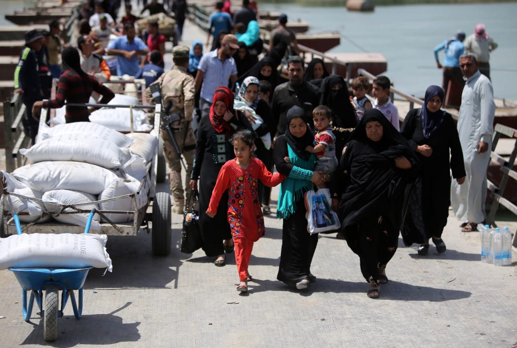 Displaced Sunni Iraqis, who fled the violence in Ramadi, arrive at the outskirts of Baghdad in April 2015.