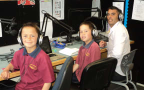 Deputy principal Tane Bennett and students broadcastiong Te Reo lessons.